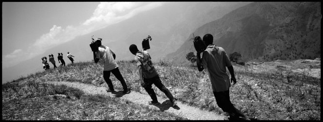 A team of men and women march along a ridge on their way to plant some of the 25,000 trees donated by Food For The Poor in Mahotière, Haiti on May 1, 2010.May 1st is Haiti's Labor Day. To celebrate, on Saturday May 1, 2010, Food For The Poor donated more than 25,000 trees to be planted in Mahotière, Haiti, a farm community in the mountains high above Port-au-Prince, where deforestation, soil erosion and hunger are prevalent. About 1,500 local people participated in a highly organized planting of the trees on the steep slopes surrounding a Food For The Poor village. The organization has built new homes there in the past year, with more currently under construction, totaling 40 homes. The participants all received boots, sneakers and a cooked lunch. Cows and donkeys were also distributed to parts of the community.